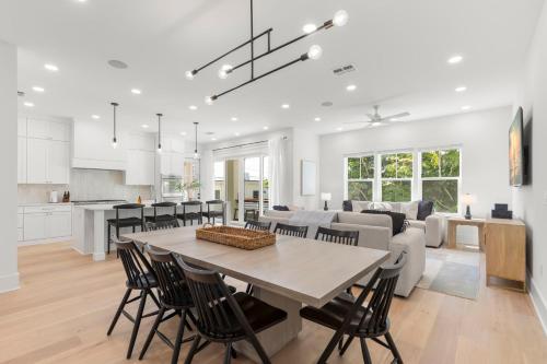 a kitchen and living room with a table and chairs at Oynx House & Jade House at the Gemma - 2 Amazing Homes Steps to Clearwater Beach in Clearwater Beach