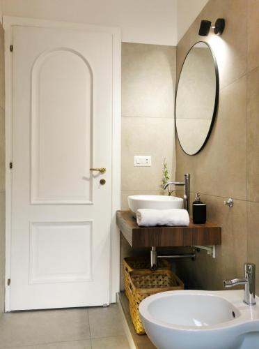 a bathroom with a white door and a sink at Domus Taura civico 48 in Terracina