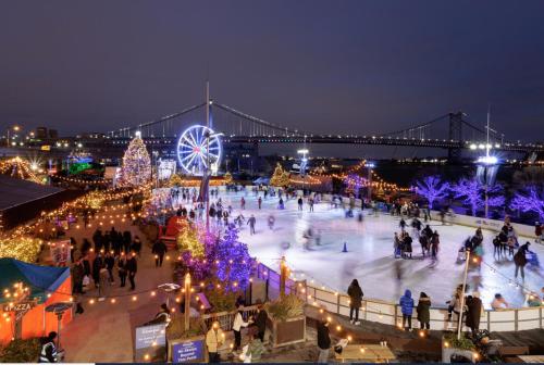 an ice skating rink with a bridge in the background at Holiday Inn Express Philadelphia Penn's Landing by IHG in Philadelphia