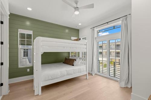 a bedroom with a white bunk bed and a window at Jade House at The Gemma in Clearwater Beach
