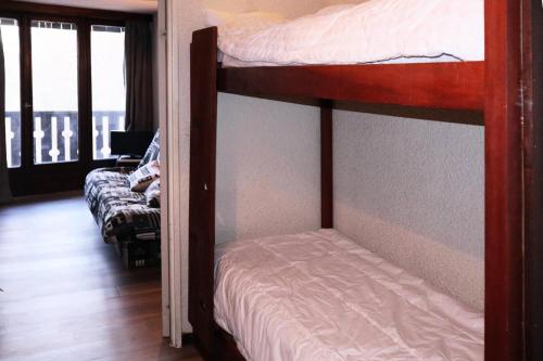 a bedroom with two bunk beds and a balcony at Résidence La Mazeliere - 26 MAZELIERE LES ORRES 1650 MAE-3644 in Le Mélézet
