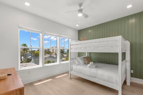 a bedroom with a white bunk bed and a window at Jade House at The Gemma in Clearwater Beach