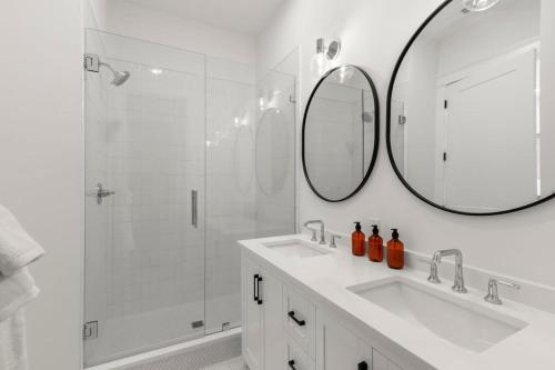 a white bathroom with a sink and a shower at Jade House at The Gemma in Clearwater Beach