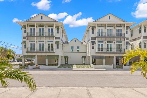 a large apartment building with white windows at Jade House at The Gemma in Clearwater Beach