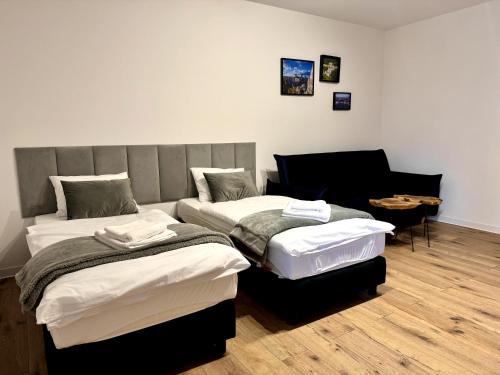 a room with two beds and a couch at Sweet Apartments in Żarki