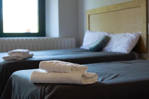 two towels are sitting on top of two beds at Can Paulí in Ultramort