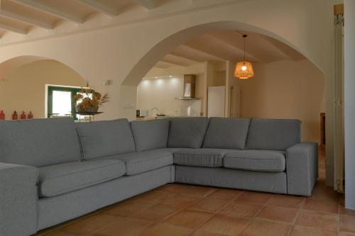 a living room with a gray couch in a room at Can Paulí in Ultramort