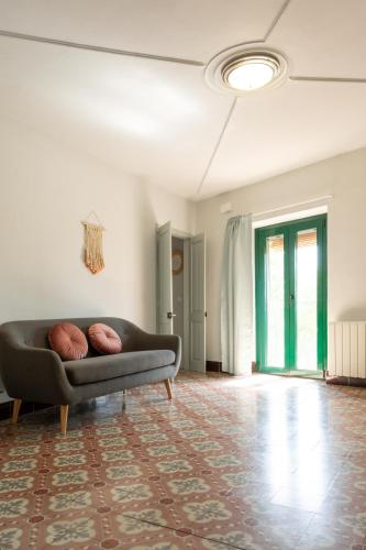 a living room with a couch and a rug at Can Paulí in Ultramort