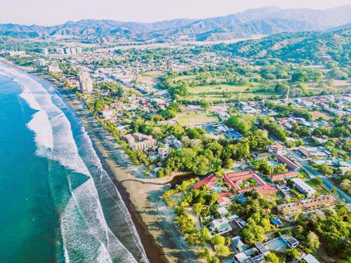 an aerial view of a beach and the ocean at Beach Break Resort & CR Surf Camp in Jacó