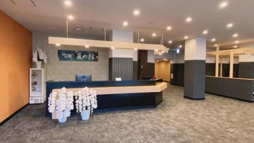 a lobby with a reception desk with white flowers at Arashi no Yakata in Hamamatsu