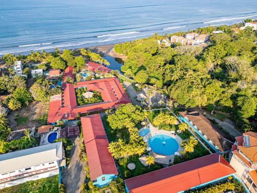 an aerial view of a resort with a swimming pool and the ocean at Beach Break Resort & CR Surf Camp in Jacó