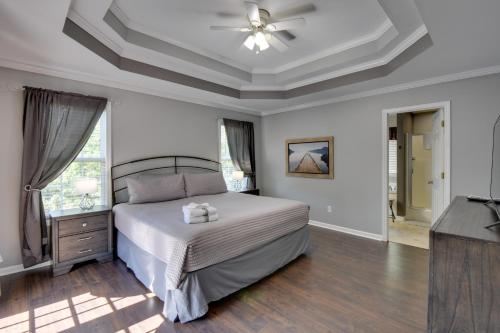a bedroom with a bed with a ceiling fan and a television at Cleveland Retreat with Deck 2 Mi to Winery! in Cleveland