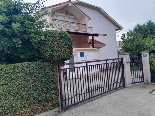 a gate in front of a white house at Goshevski Apartment in Gevgelija