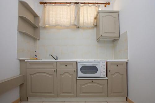 a kitchen with a sink and a microwave at Blue Marine Village in Chalkida