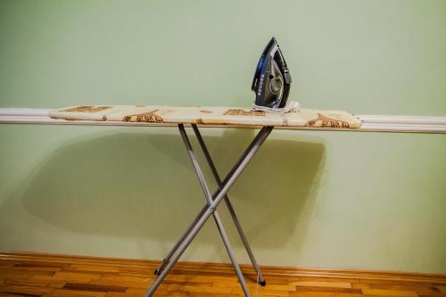 a table with a iron on top of it at Babylon Apartments in Rivne