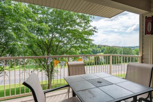 a patio with a table and chairs on a balcony at 2BR Walk-In Condo - Near the 76 Strip - 2 Pools - FREE TICKETS INCLUDED - FHF-11 in Branson