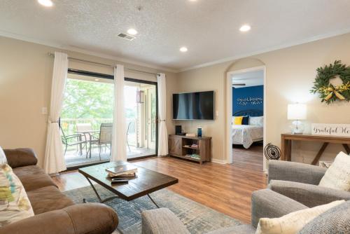 a living room with a couch and a table at 2BR Walk-In Condo - Near the 76 Strip - 2 Pools - FREE TICKETS INCLUDED - FHF-11 in Branson
