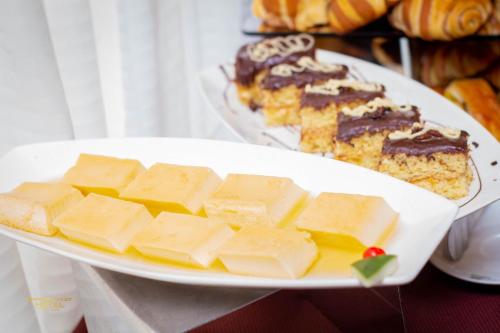 a plate of cheese and cake on a table at Airport West Hotel in Accra