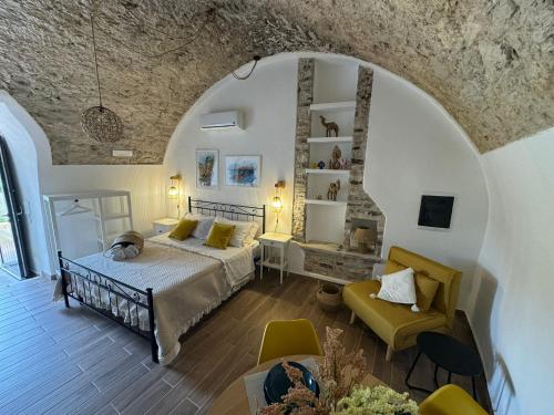 a bedroom with a bed and a chair in a room at Les Petites Maisons in Rodi Garganico