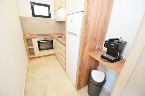 a small kitchen with a small refrigerator at Radgost Kotor Apartments in Kotor