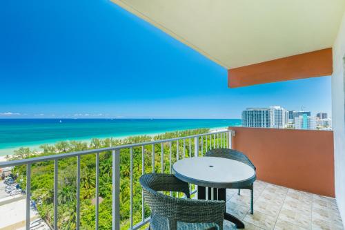 a balcony with a table and chairs and the ocean at Fort Lauderdale Beach Resort by Vacatia in Fort Lauderdale