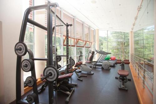 a gym with a bunch of tread machines in a room at Hotel Yastrebets Wellness & Spa in Borovets