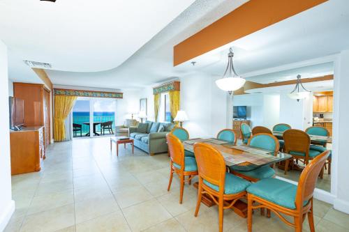 a dining room and living room with a table and chairs at Fort Lauderdale Beach Resort by Vacatia in Fort Lauderdale