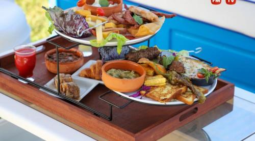 a tray with three plates of food on a table at Hotel Best Beach- Family Only in Chott Meriem