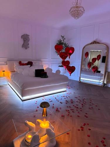 a living room with a bed and red hearts on the floor at Les chambres d excellence Spa in Sète