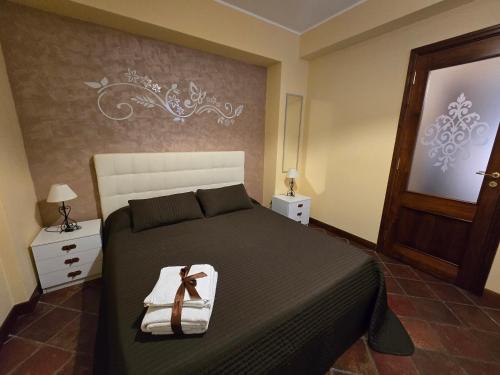 a bedroom with a bed with a black bedspread at Casa La Ferula apt1 vicino al mare e Taormina in SantʼAlessio Siculo