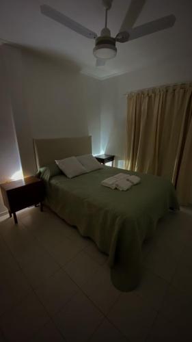 ein Schlafzimmer mit einem grünen Bett mit zwei Handtüchern darauf in der Unterkunft Hermoso Departamento Familiar y Tranquilo in Santa Fe