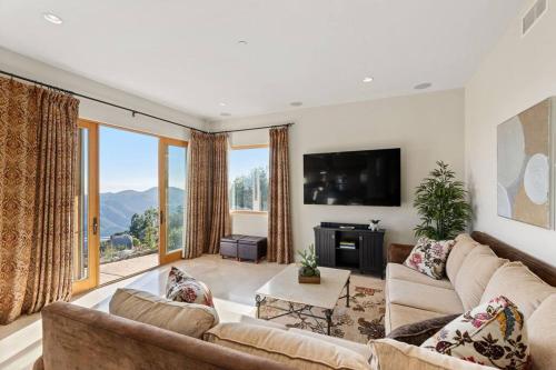 a living room with a couch and a tv at Mediterranean Haven with Views in Escondido in Escondido