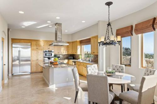 a kitchen with a table and a dining room at Mediterranean Haven with Views in Escondido in Escondido