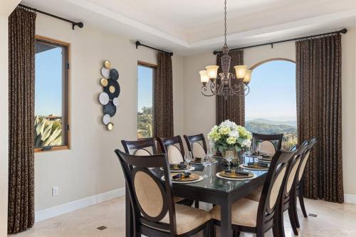 a dining room with a black table and chairs at Mediterranean Haven with Views in Escondido in Escondido