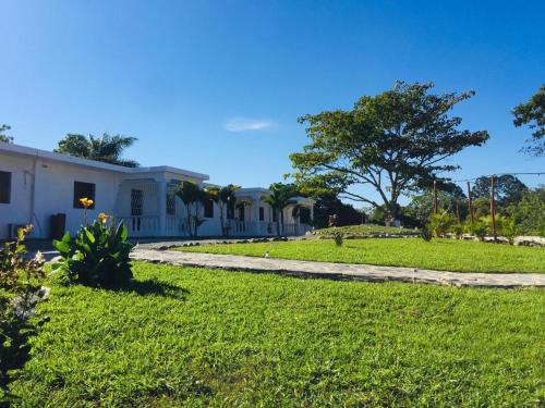 a house with a green lawn in front of it at Colina Buena vista A4 in Jarabacoa