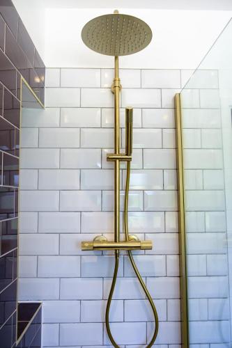 a shower in a bathroom with a white tile wall at The Wave Cottage - 3 Bedroom with off road Parking for 3 Cars or Vans & EV point in Pilning
