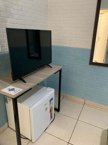 a flat screen tv sitting on top of a table at Soul do Mar Hostel in Cabo Frio