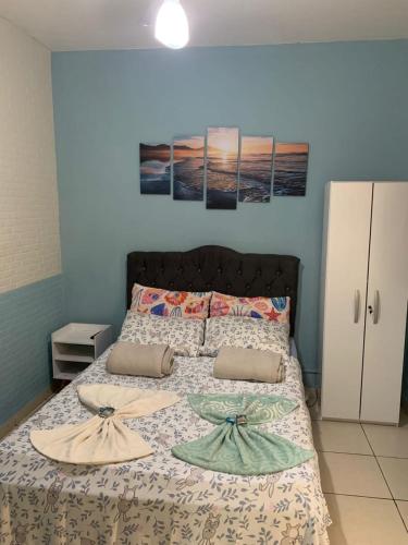 a bedroom with a bed with two surfboards on it at Soul do Mar Hostel in Cabo Frio