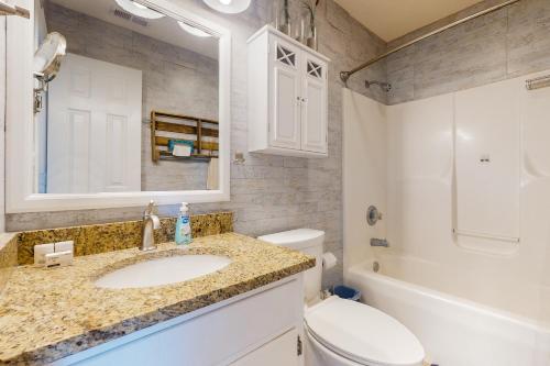 a bathroom with a sink and a toilet and a mirror at Bermuda Place in North Topsail Beach