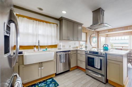 a kitchen with stainless steel appliances and a sink at Bells Beauty in Langley