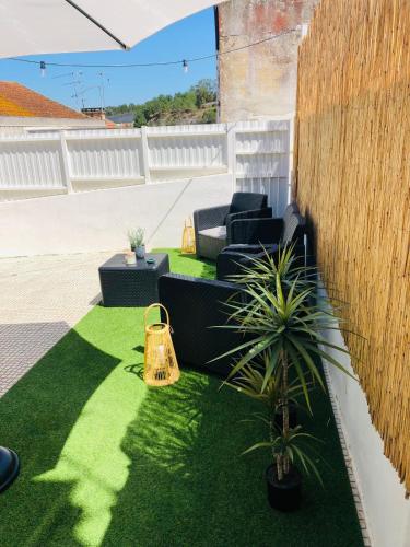 a garden with a couch and a potted plant at City Break by StaySalmar in Torres Vedras