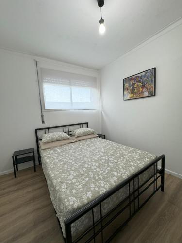a bedroom with a bed in a white room at Esposende Apartment 8B in Esposende