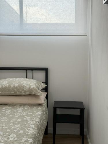 a bedroom with a bed and a nightstand next to a window at Esposende Apartment 8B in Esposende