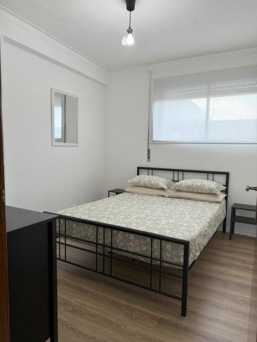 a bedroom with a bed in a white room at Esposende Apartment 8B in Esposende