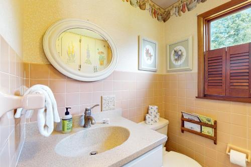 a bathroom with a sink and a mirror and a toilet at Turtle Bay in Minocqua