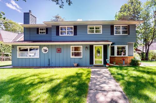 a blue house with a green lawn at Turtle Bay in Minocqua