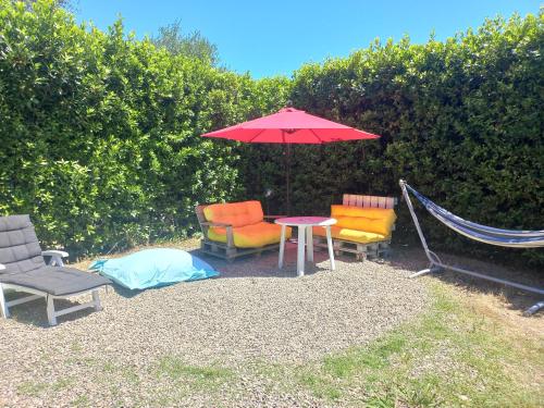 a patio with chairs and a table with an umbrella at Casa Gelso in Scandicci