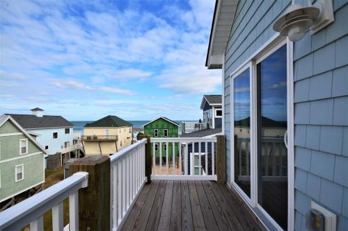 a balcony with a view of the ocean from a house at Topsail Turvy in North Topsail Beach