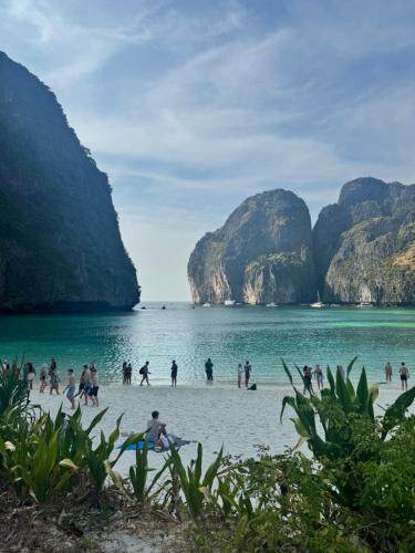 a group of people on a beach in the water at Hack Patong Beach Hotel in Patong Beach