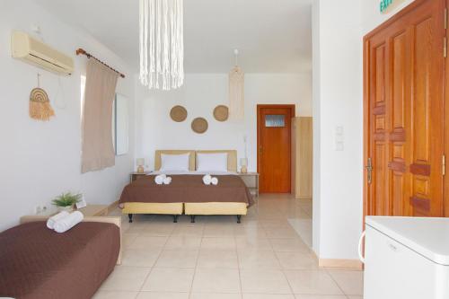 a bedroom with two beds and a kitchen at Blue Marine Village in Chalkida